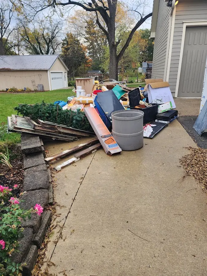 Dumpster being loaded with debris for Roofing Dumpster Rental in Portola Valley